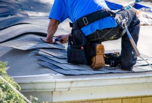 Repairing,The,Roof,Of,A,Home;,A,Worker,Replaces,Shingles